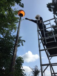 A colleague of mine working on an access tower (struggling to get close enough to work on the light)