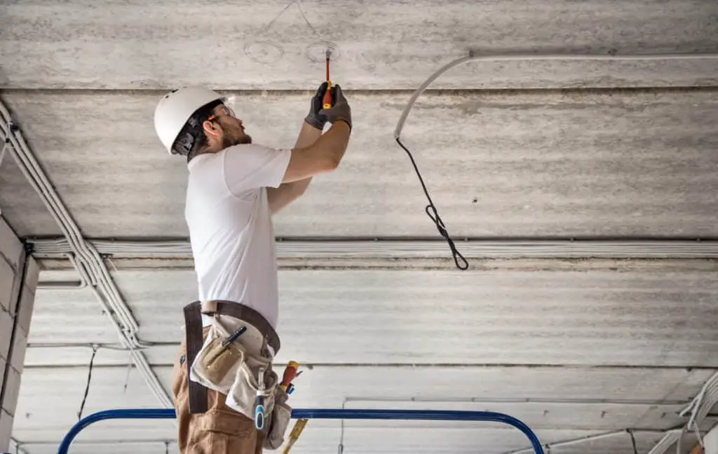 A commercial electrician working on a shop refit