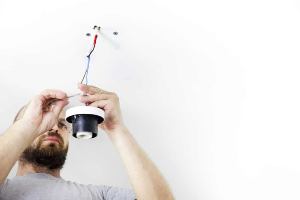 Electrician replacing a light fitting