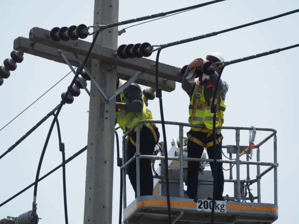 Electricians heigh in the air repairing power lines