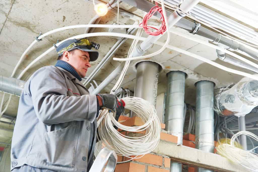 Electrician looking stressed by number of cables