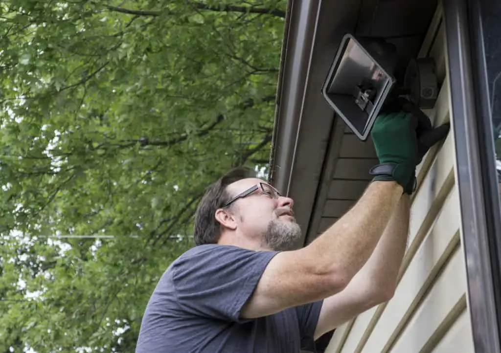 An Electrician installing a light fitting