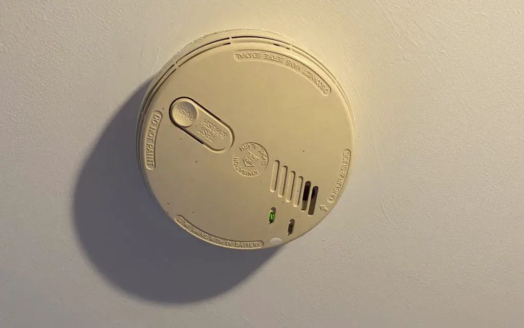 A mains powered smoke alarm on the ceiling