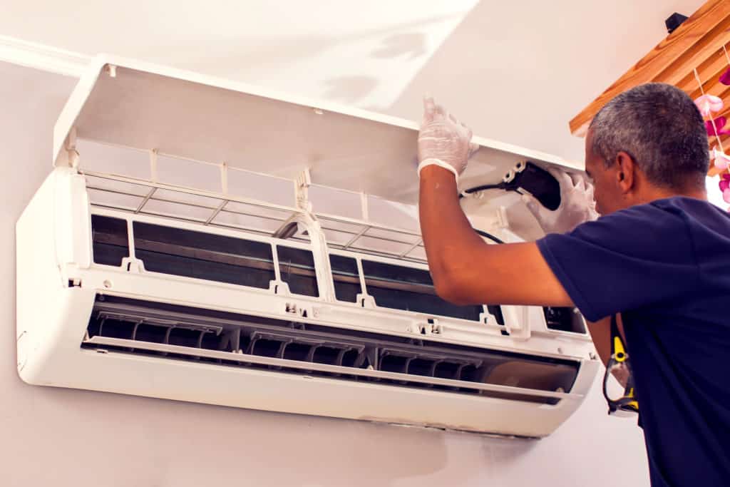 Electrician fixing air conditioning