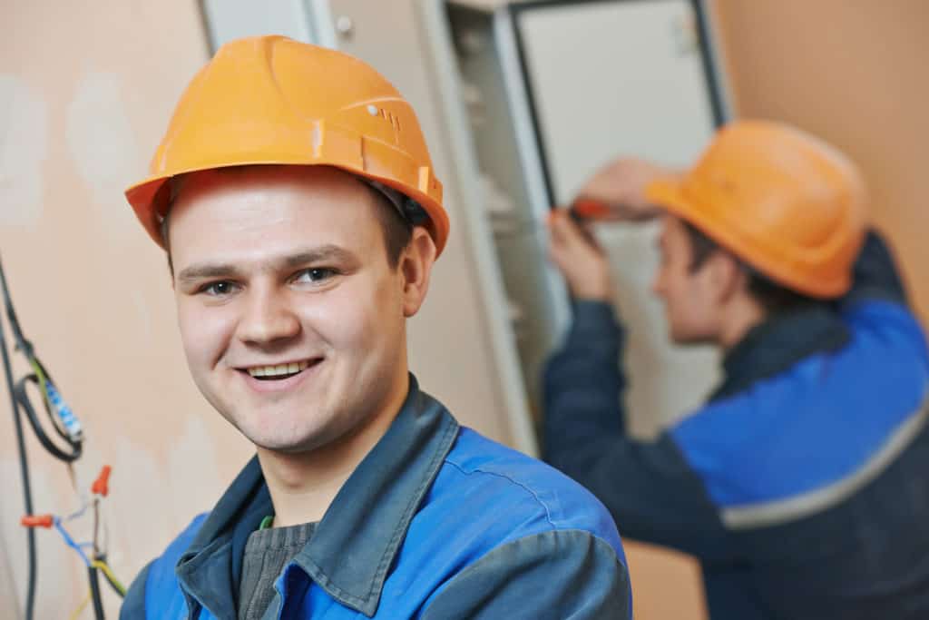 Electrician looking very happy at work