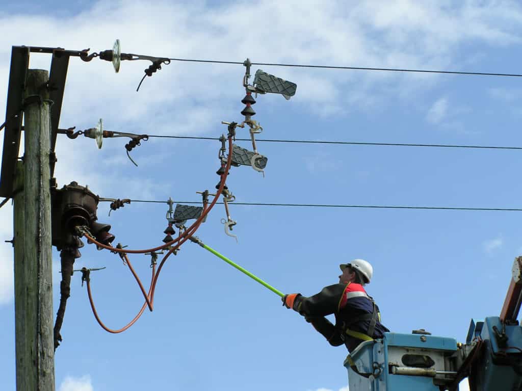 Lineman closing switch on a high voltage power line