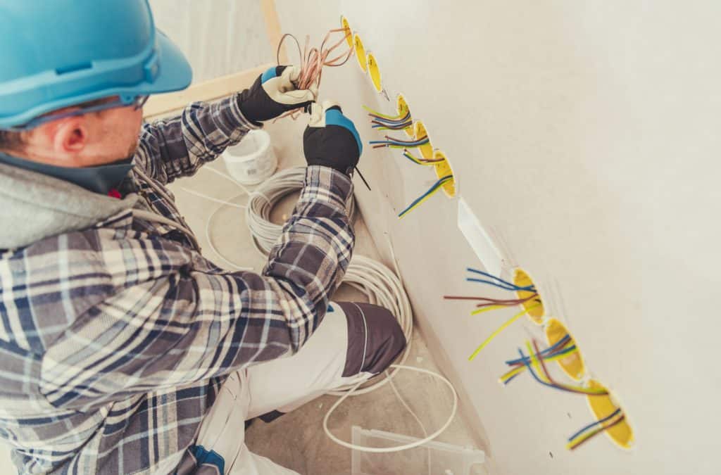 Electrician's mate completing the first fix wiring