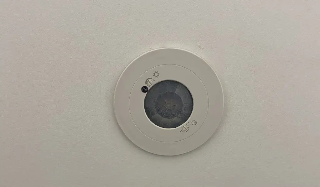 Close up motion sensor showing the settings that can be adjusted to control the lights.
