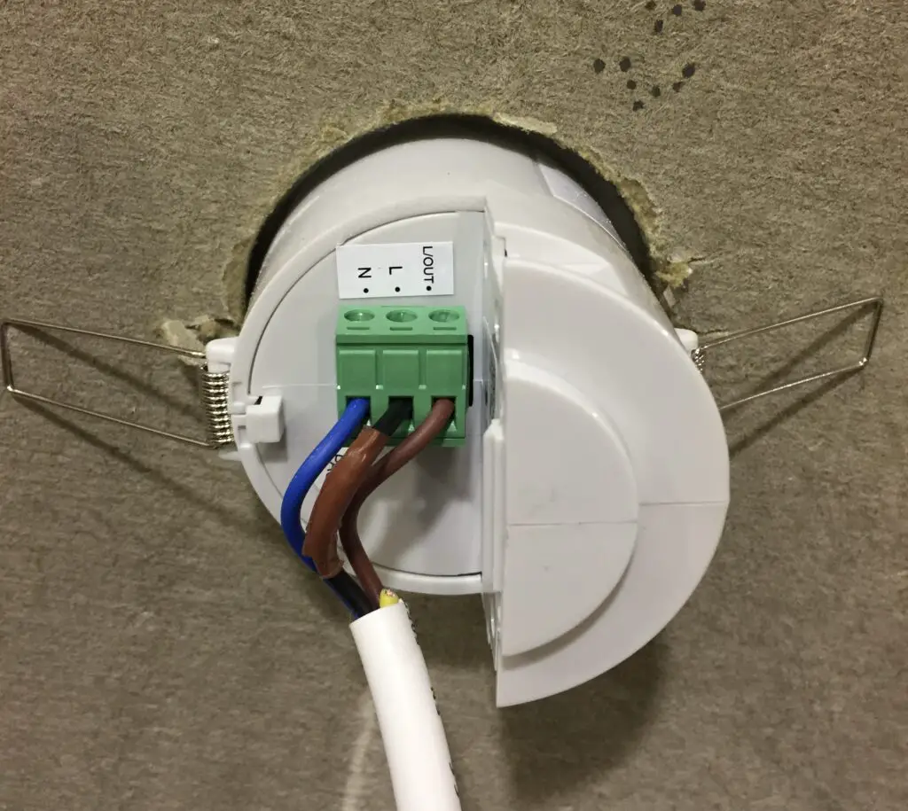 An above-the-ceiling view of a PIR sensor I installed independently of the light fittings